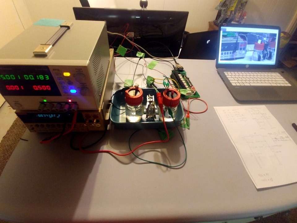 Relay, test leads, and a container apparatus on a workbench.